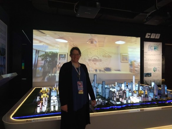 Me, standing in front of a lighted model of a city.