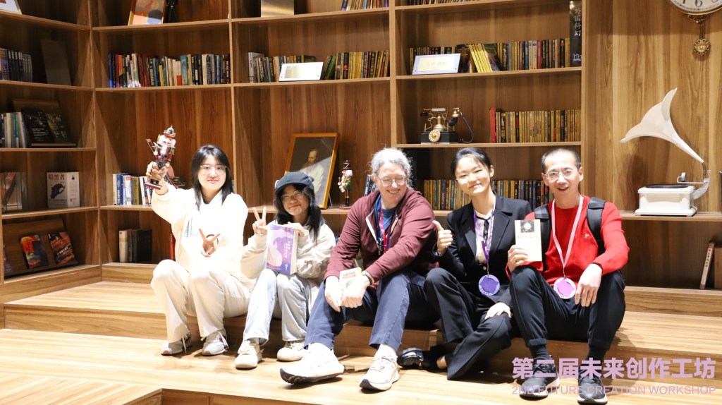 Me and my students sitting on a low step in a decorative library. Three of us are holding books and one person is holding up a Nutcracker.